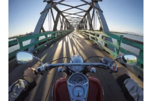 motorcyclist riding on bridge